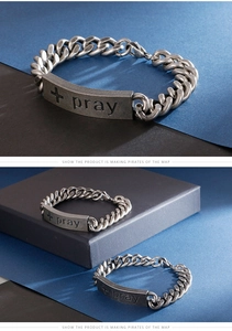 Detail of vintage stainless steel cuban chain bracelet with pray cross curved plate