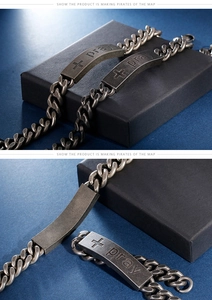 Detail view of vintage stainless steel prayer bracelet with cross and pray engraving