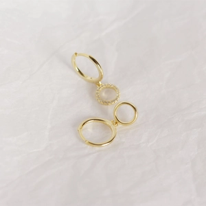 Detailed close-up of gold s925 silver hoop earrings with shimmering pavé zircons