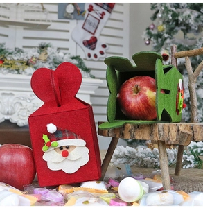 Detail of Christmas non-woven felt gift bag featuring 3D Santa Claus and heart handle