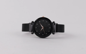 Detail view of starry sky dial with rhinestone hour markers and Milanese mesh strap