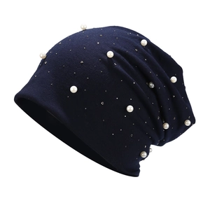 Detailed view of navy blue cotton slouchy beanie with pearls and small crystals