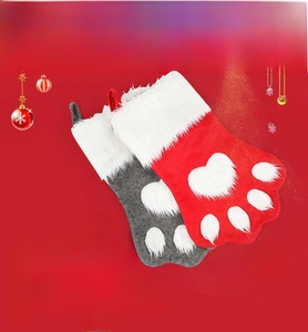 Close-up of paw-shaped Christmas stockings with plush white faux fur trim and hanging loops