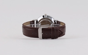 Detail of genuine brown leather strap with silver stainless steel buckle and fine stitching