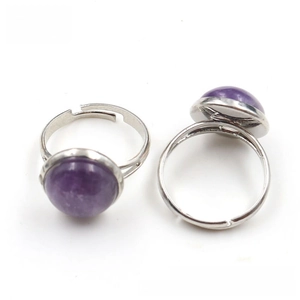 Close-up of adjustable silver rings featuring round purple crystal tiger eye stones