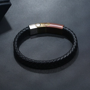 Close-up of black braided leather bracelet with tri-color interlocking magnetic clasp