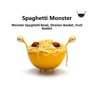 Close-up of yellow monster-shaped pasta strainer bowl with eye-shaped handles