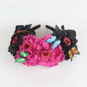 Detailed view of Mexican floral headband with colorful silk roses and lifelike butterflies