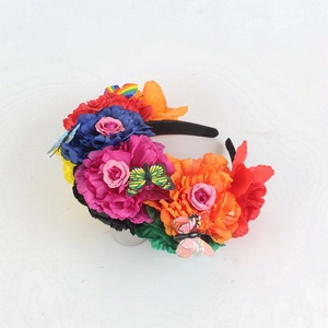 Detail of Mexican headband with colorful silk peonies and decorative 3D butterflies