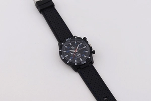 Close-up of black sports chronograph watch with blue accents and silicone strap