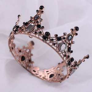Detailed macro view of rose gold crown featuring black gemstones and crystals setting