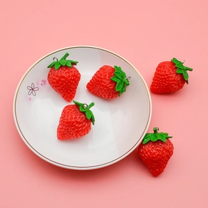 Set of 5 realistic PVC strawberry pendants with metal rings on a pink background