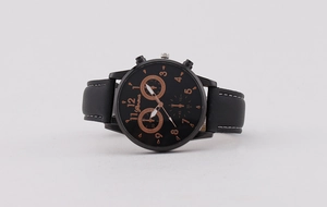 Detail of classic black leather strap with white stitching on a business quartz watch