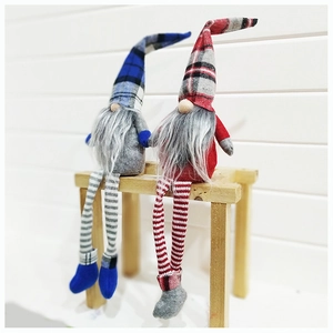 Christmas gnomes with blue and red plaid hats sitting on a wooden bench decoration