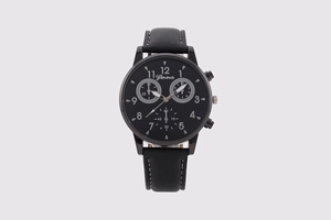 Close-up of black quartz watch dial with white numerals and decorative sub-dials