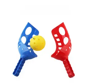 Close-up of red and blue plastic catching rackets with a yellow hollow launch ball