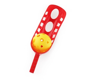 Detail of red scoop launcher with ergonomic handle and yellow practice ball for outdoor play