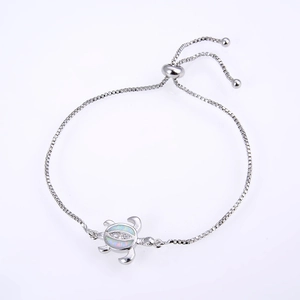 Detailed close-up of a silver turtle bracelet with opal inlay and adjustable box chain