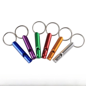 Close-up of small aluminum emergency whistles in six metallic colors with keyrings