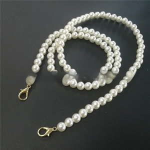 Detail of 10mm white pearl strap with gold lobster clasps for bags or phone accessories