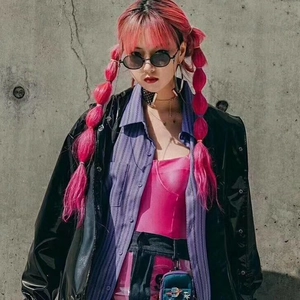 Street style view of women wearing retro black oval sunglasses with punk leather jacket