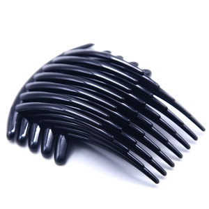 Close-up of 7-tooth black plastic hair combs with rounded edges for DIY hair accessories