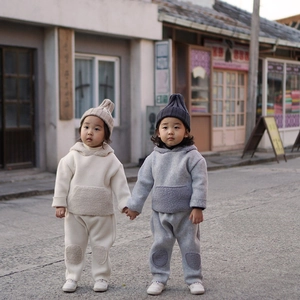 Kids warm polar fleece tracksuit with hooded sweatshirt and patch trousers on street