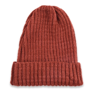 Close-up of rust red ribbed knit beanie showing soft wool texture and wide folded cuff