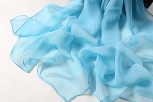 Close-up of a blue chiffon scarf showing its light, transparent, and soft fabric texture