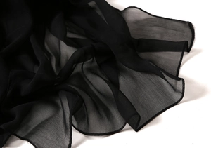 Close-up of lightweight black sheer chiffon scarf with professional hemmed edges
