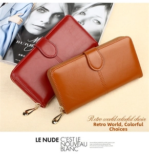 Detail of oil-wax leather texture on long zipper wallets in burgundy and caramel brown