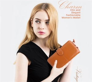 Close-up of caramel leather long wallet featuring a flip-top buckle and textured surface