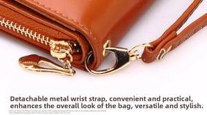 Close-up of caramel leather long wallet with gold zipper and detachable wrist strap