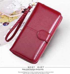 Detailed view of wine red oil wax leather long wallet with wristlet strap and zipper