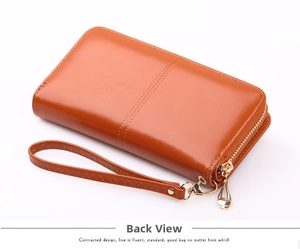 Detailed back view of orange faux leather long wallet with wristlet strap and zipper