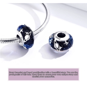 Macro shot of S925 sterling silver starry sky charm with faceted blue glass bead