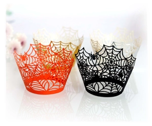 Detail of laser-cut spider web cupcake wrappers in black, red, gold, and white colors