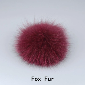Close-up of fluffy dark pink fox fur pompom showing soft texture and premium quality
