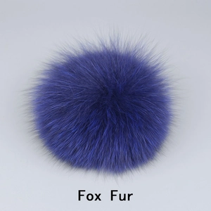 Detail of premium fluffy purple fox fur pom pom with soft dense texture for accessories