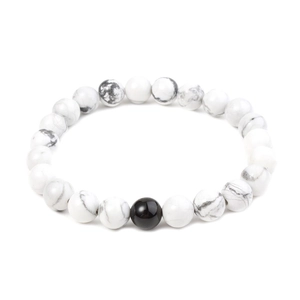 Macro view of 8mm white turquoise beads with grey marble texture and black center bead