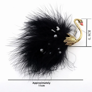 Detail shot of swan brooch showing black ostrich feathers and pearls with 11cm size guide