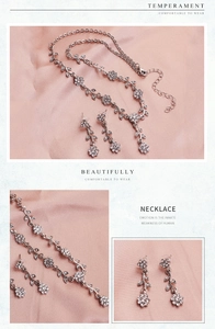 Detail of silver floral necklace and earrings set with sparkling rhinestones on pink fabric