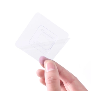 Transparent adhesive wall hook showing self-adhesive backing film removal for easy mounting