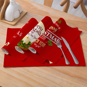 Red Christmas cotton linen placemats with Merry Christmas lettering on a wooden table