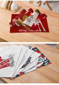 Detailed view of red Christmas placemats with festive linen texture and holiday patterns