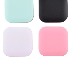 Top view of four matte contact lens cases in mint green, black, lilac, and pink colors
