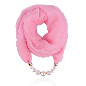 Detail of pink chiffon scarf necklace with artificial pearls and golden metal fastener