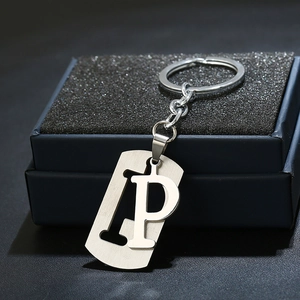 Silver stainless steel keychain with letter P detail hanging on a black jewelry gift box
