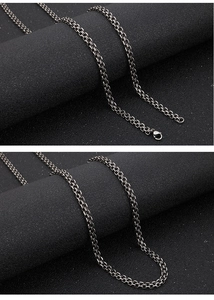 Detailed view of silver stainless steel double layered O-chain on a black display stand