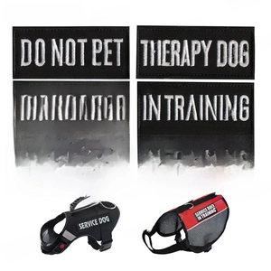 Detail view of black and white embroidered SERVICE DOG patches for pet harnesses
